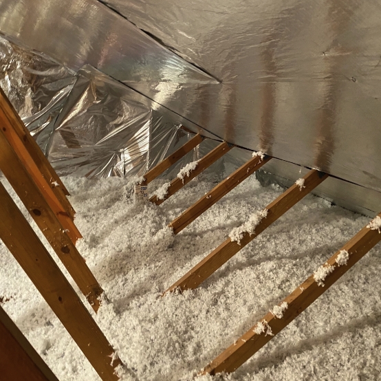 An attic with a radiant barrier installed and insulation added.
