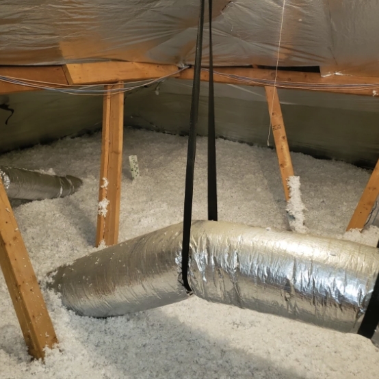 An attic with insulation and a radiant barrier installed.