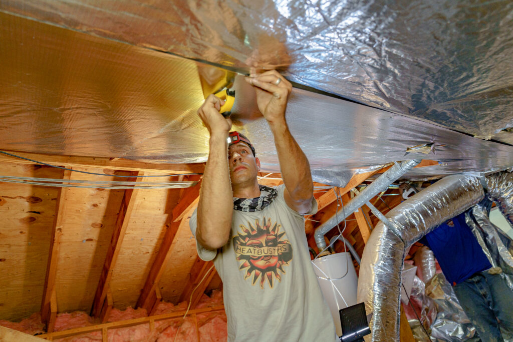 contractor-stapling-radiant-barrier-in-attic-2