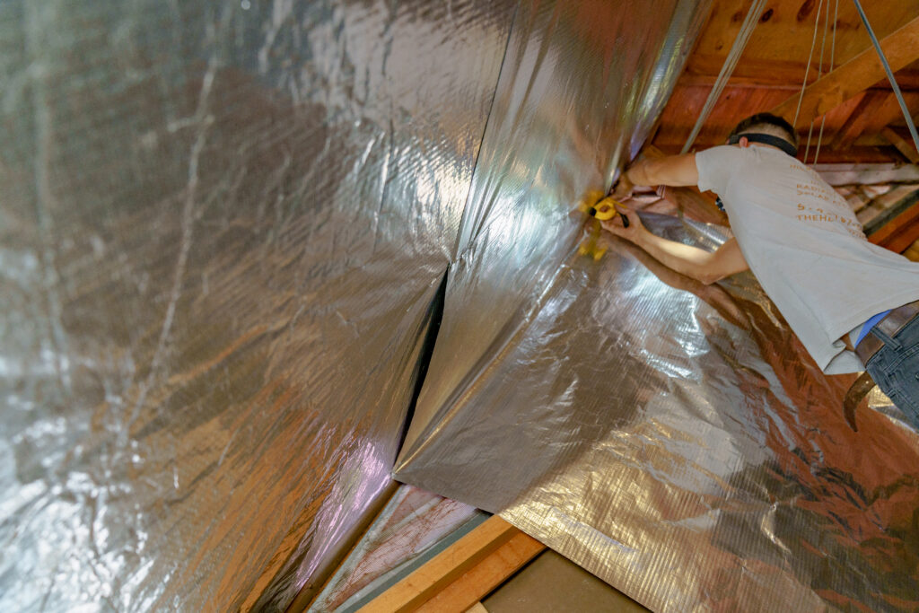 contractor-stapling-radiant-barrier-in-attic